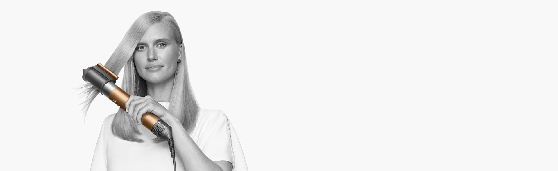 Model using Dyson Airwrap multi-styler