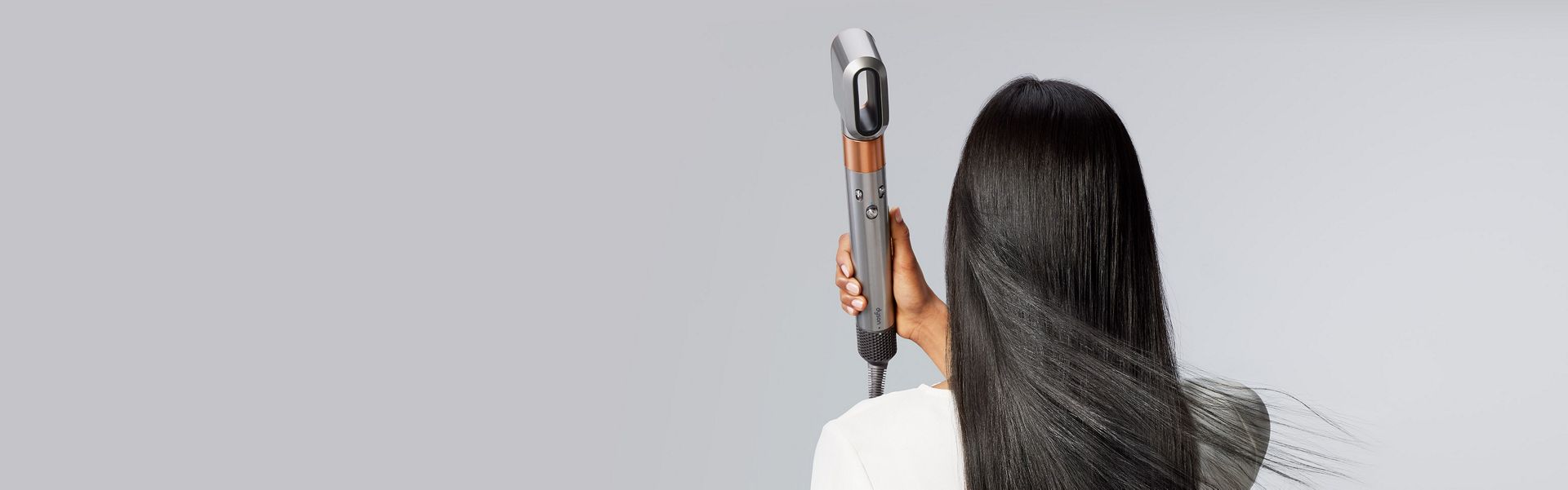 Model using the fast dryer to dry hair