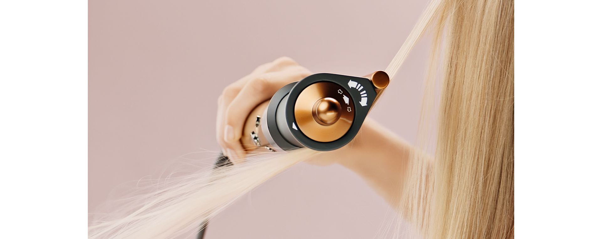 Model with type 1 hair using the Corrale smoothing dryer attachment to hide flyaways.