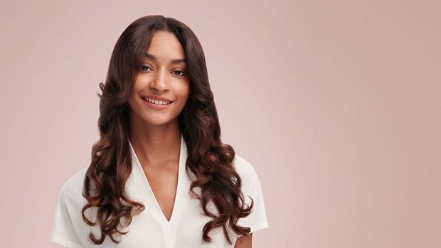 Model wearing a curly blow out style
