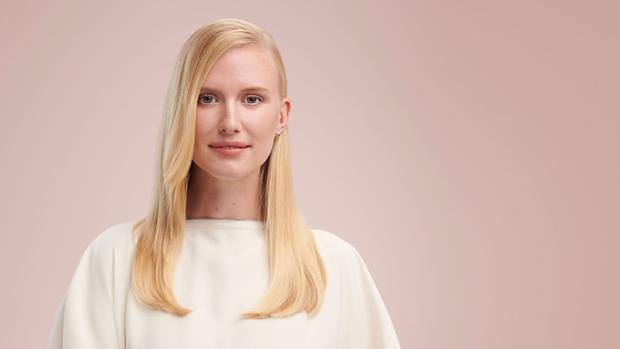 Model wearing a sleek side part style