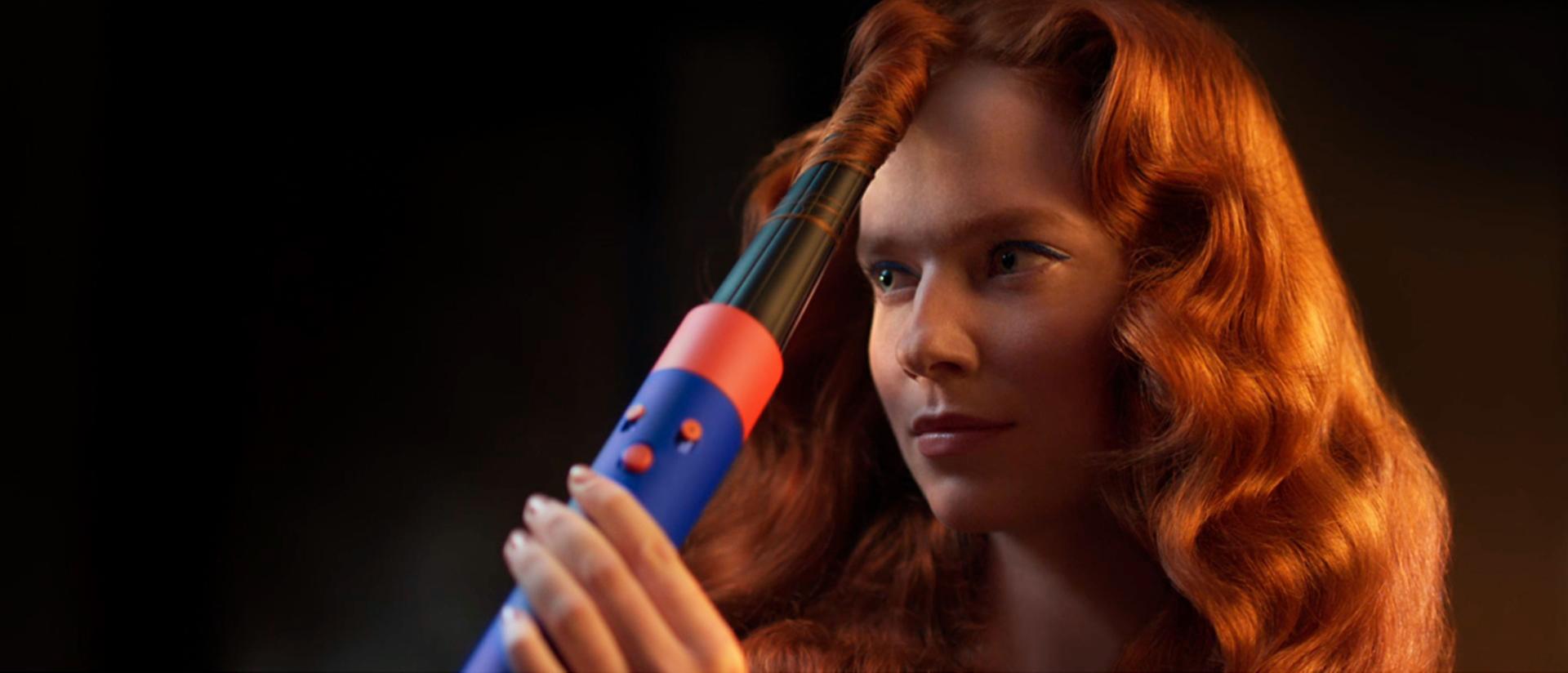 A redhead model curls her hair with the Dyson Airwrap i.d. and Conical Airwrap barrel.