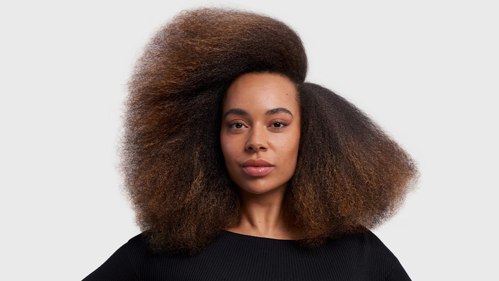 Model with stretched blow out styled hair.