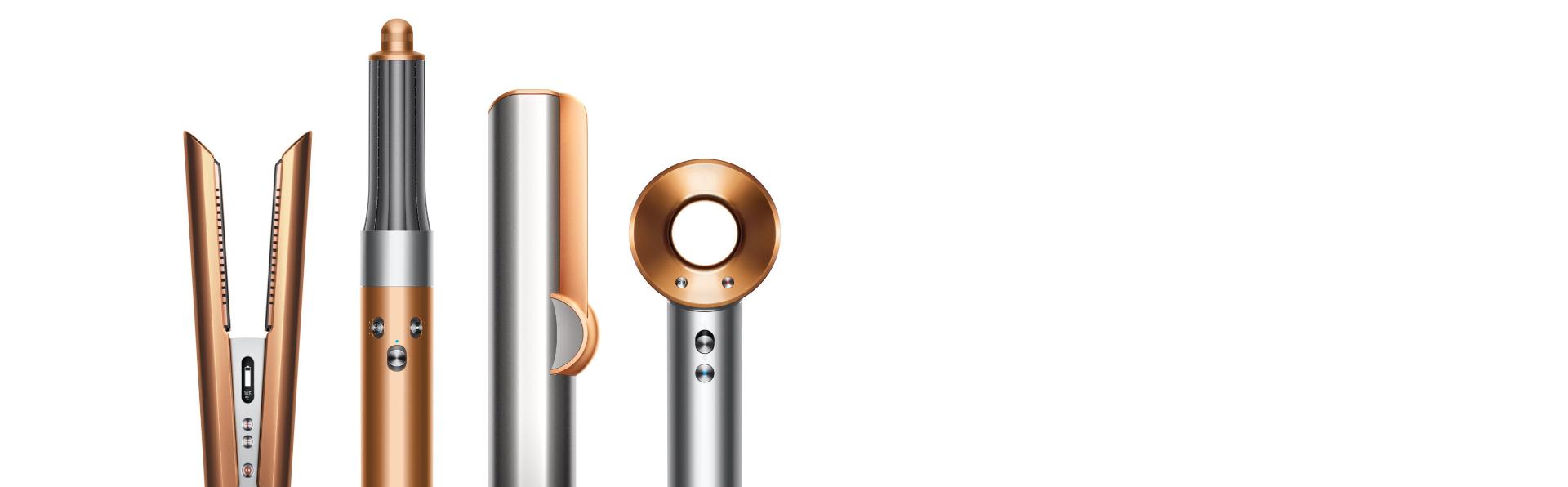 تشكيلة من أجهزة دايسون للعناية بالشعر باللون النحاسي والنيكل.