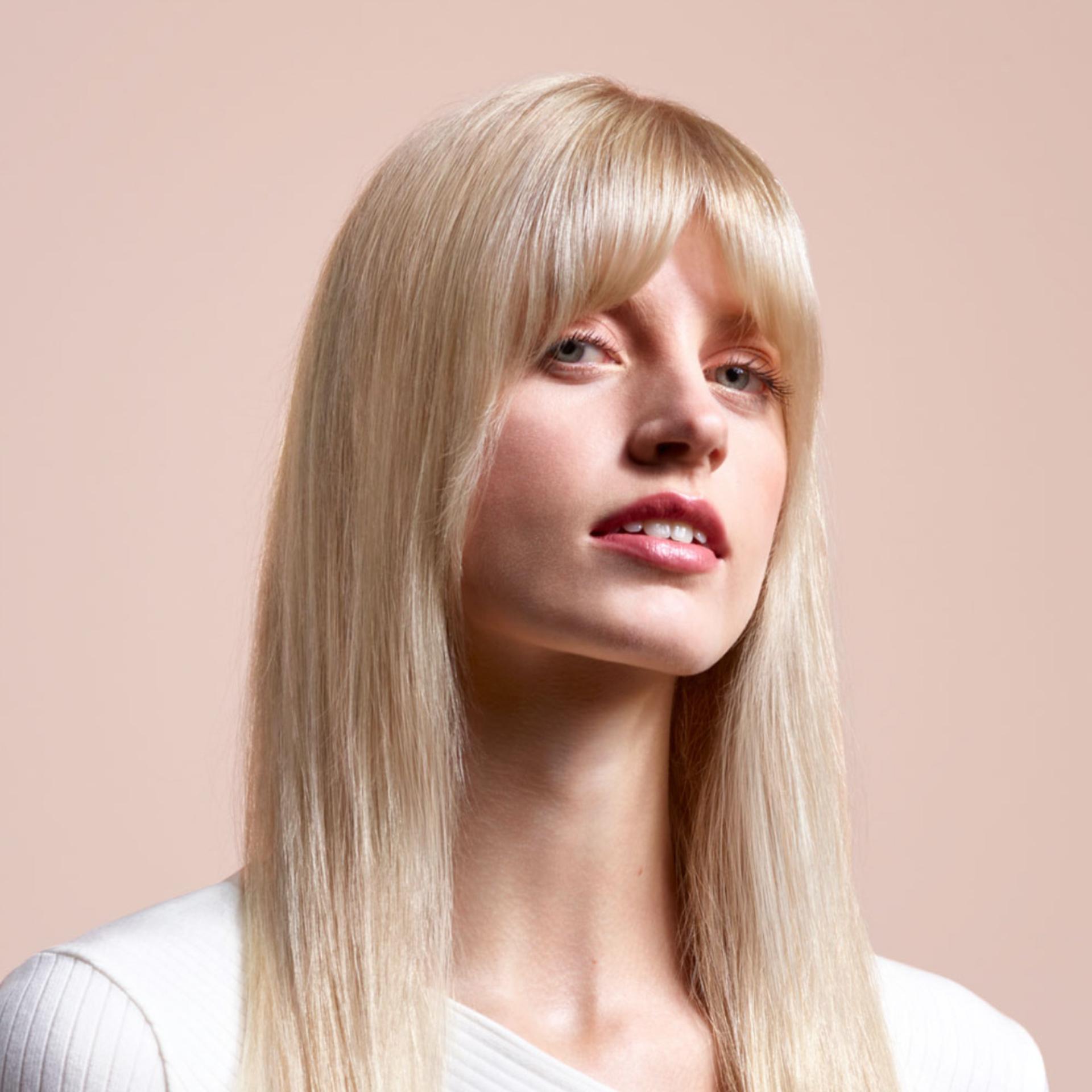 A model with long, blonde hair wearing a straight style.