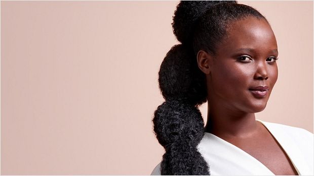 A model with long, black hair, worn in a stretched bubble puff ponytail.