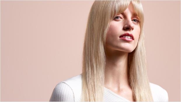 A model with long, blonde hair wearing a straight style.