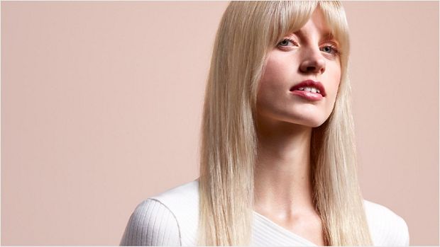 A model with long, blonde hair wearing a straight style.