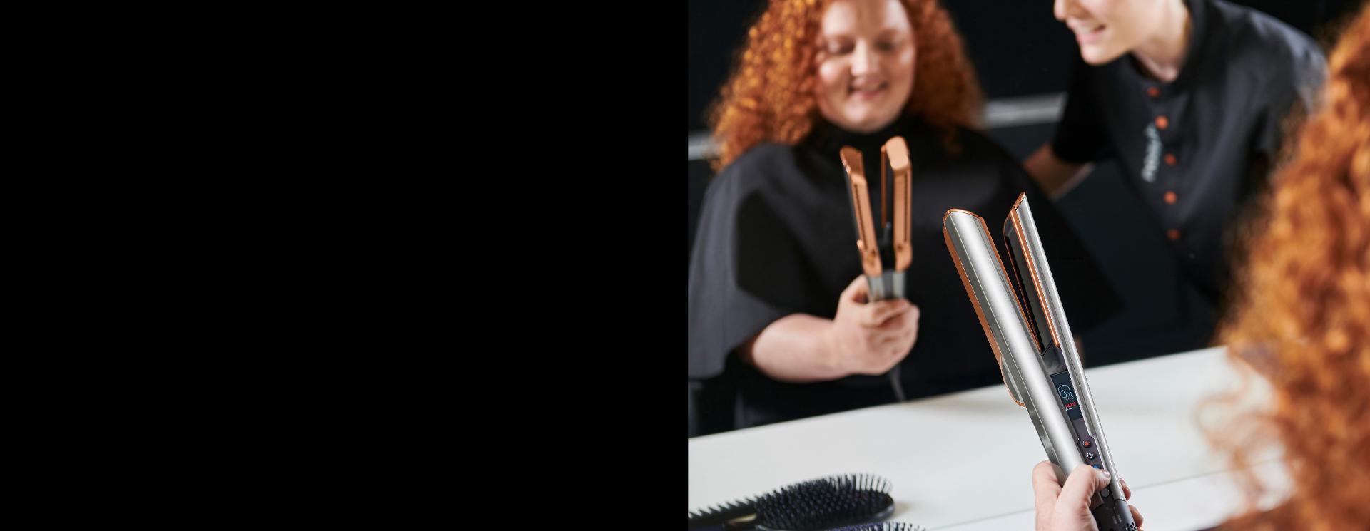 A customer tries the Dyson Airstrait straightener, guided by a Dyson Expert in store.