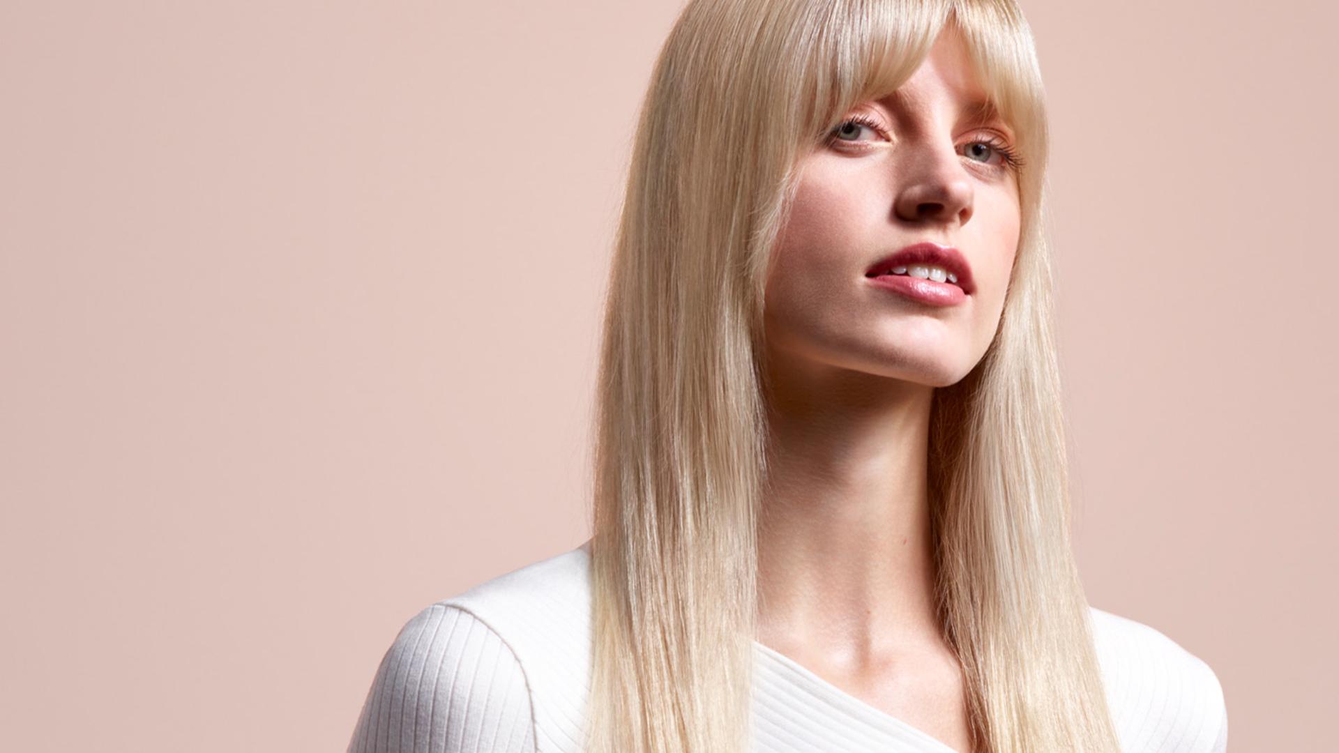 Model wearing a naturally straight blow out style.