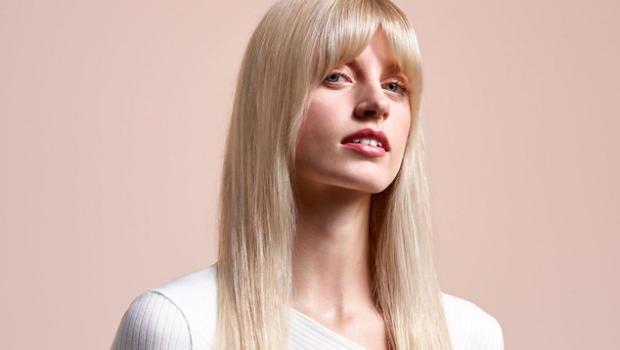 A model with long, blonde hair wearing a straight style.