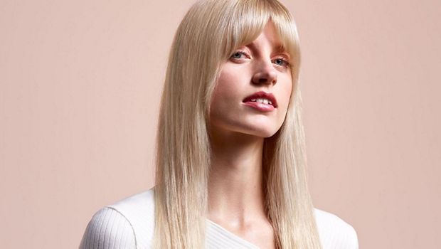 A model with long, blonde hair wearing a straight style.