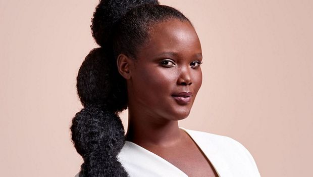 A model with long, black hair, worn in a stretched bubble puff ponytail.