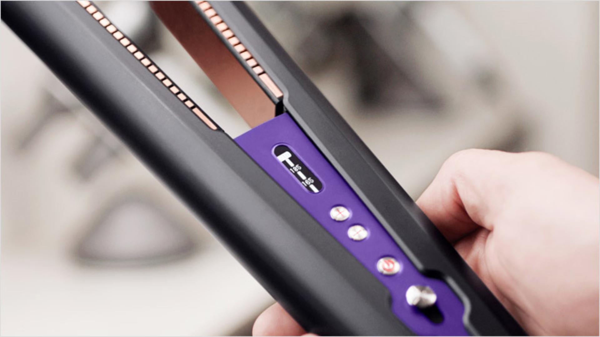 Professional stylist using a Dyson Corrale hair straightener 