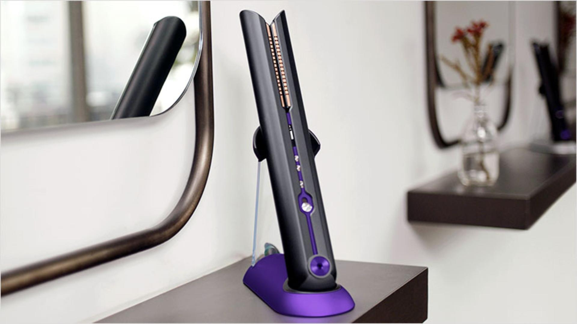 Close up of professional stylist using a cordless Dyson Corrale hair straightener