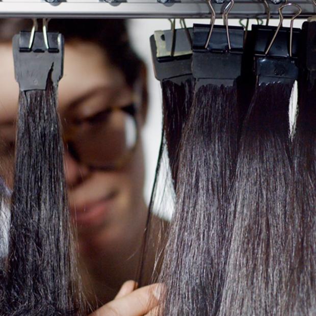 Real hair being tested in laboratory. The hair is clipped to a rail.