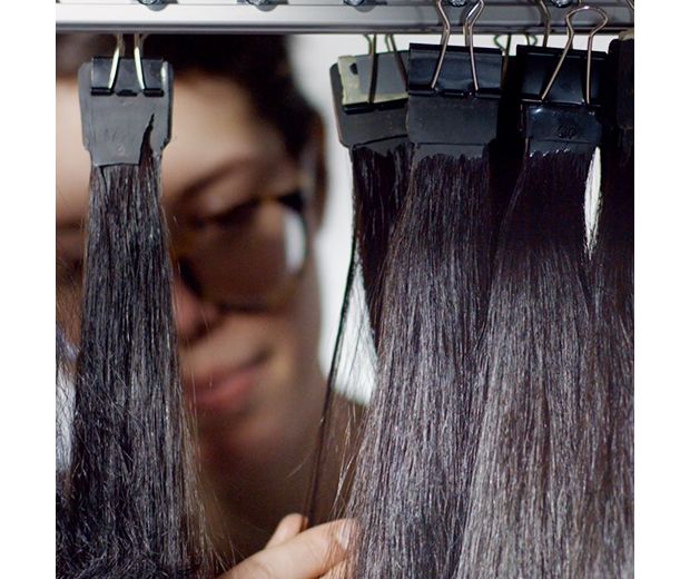 Real hair being tested in laboratory. The hair is clipped to a rail.