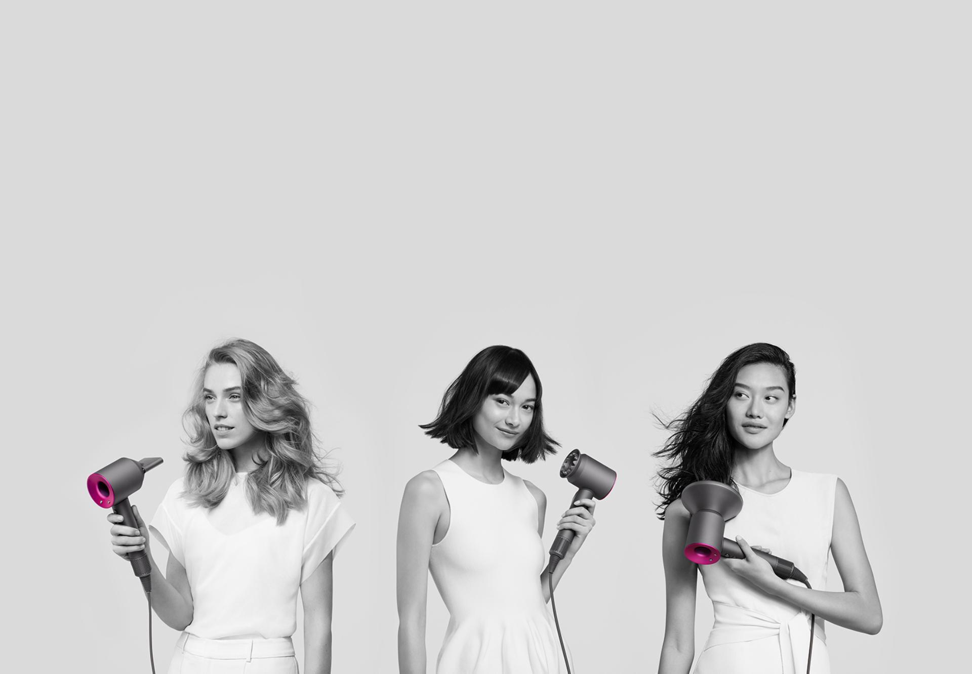 Three women using the Dyson Supersonic hair dryer