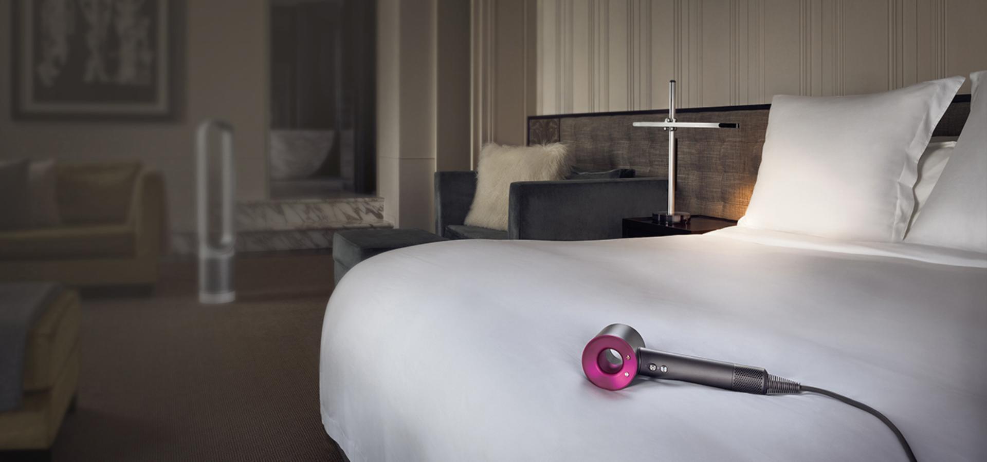 Dyson Supersonic™ hair dryer on bed