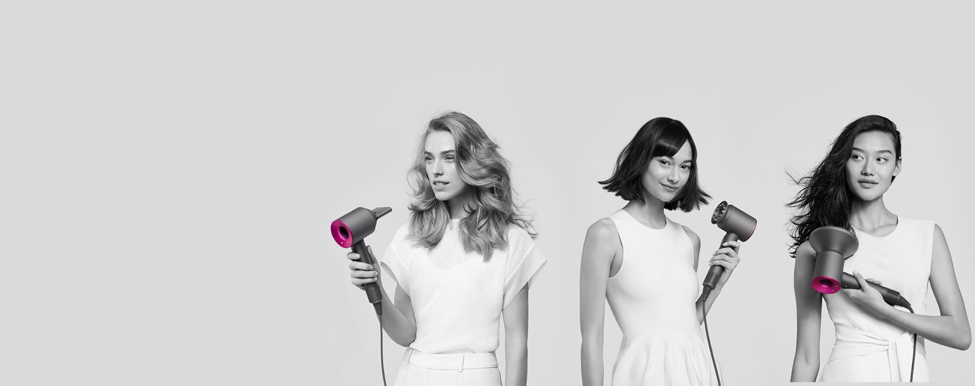Three women using Dyson Supersonic hair dryers