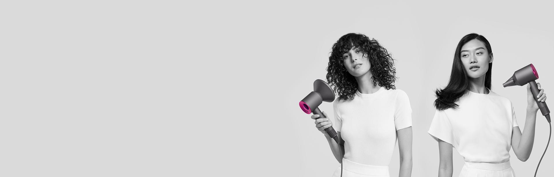 Three women using Dyson Supersonic hair dryers