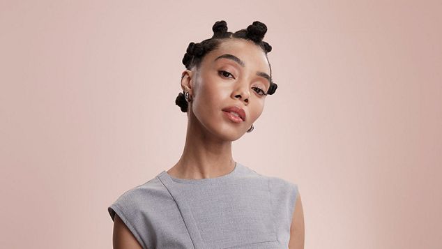 Model with curly hair.