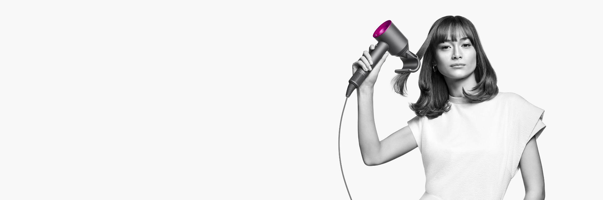 One woman using Dyson Supersonic hair dryer