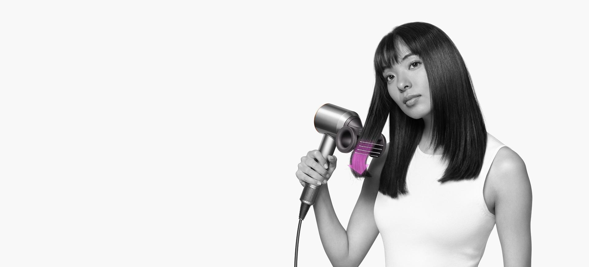 A model uses the Dyson Supersonic with Flyaway smoother attachment.