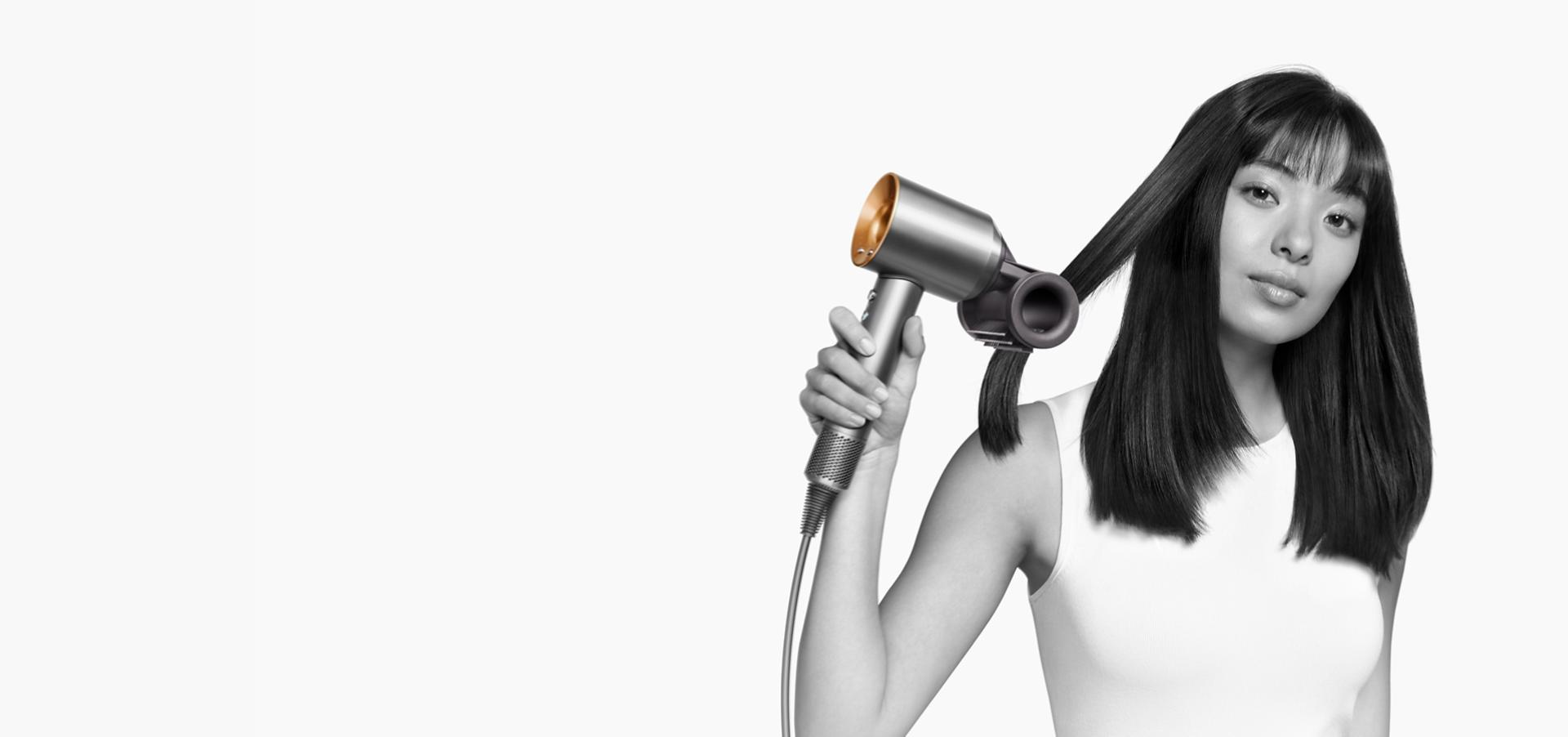 A model uses the Dyson Supersonic with Flyaway smoother attachment.