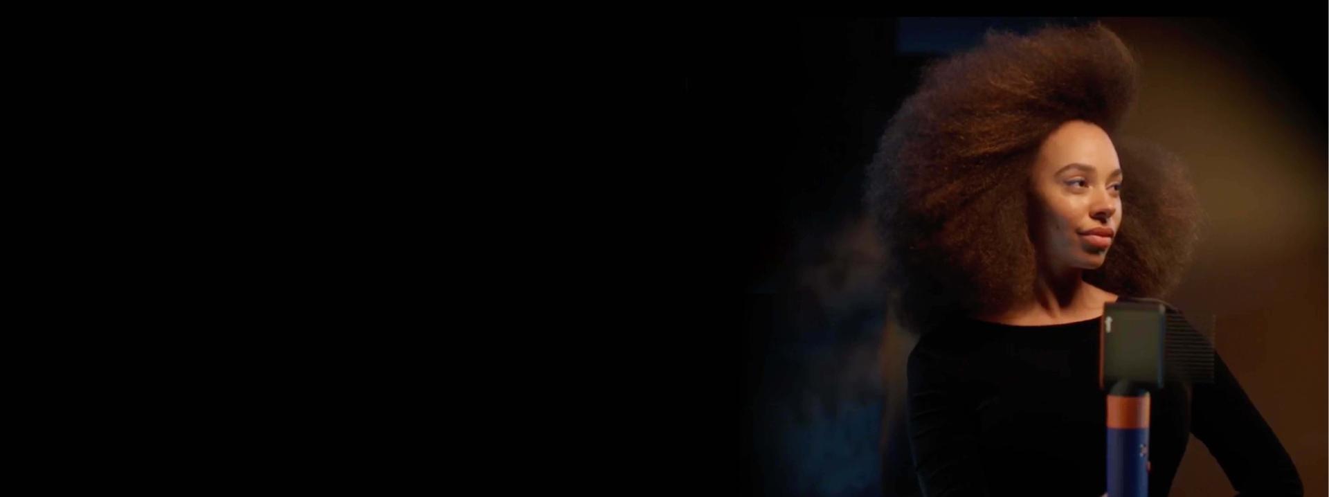 Model holding an Airwrap i.d multi-styler and dryer.