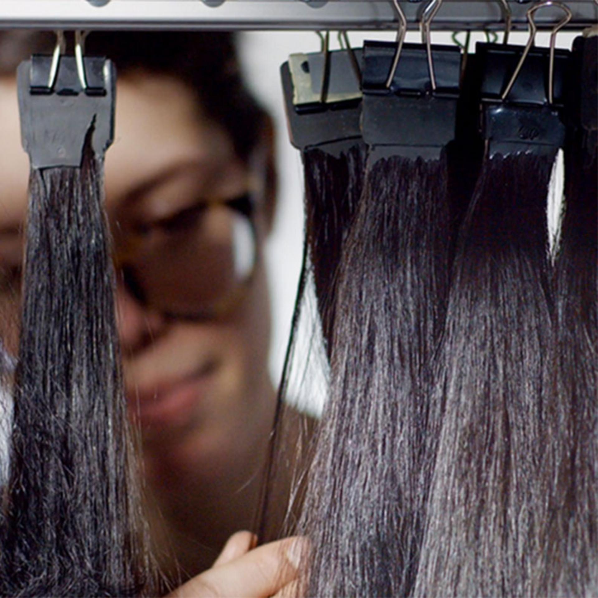 Women feeling texture of hair strands