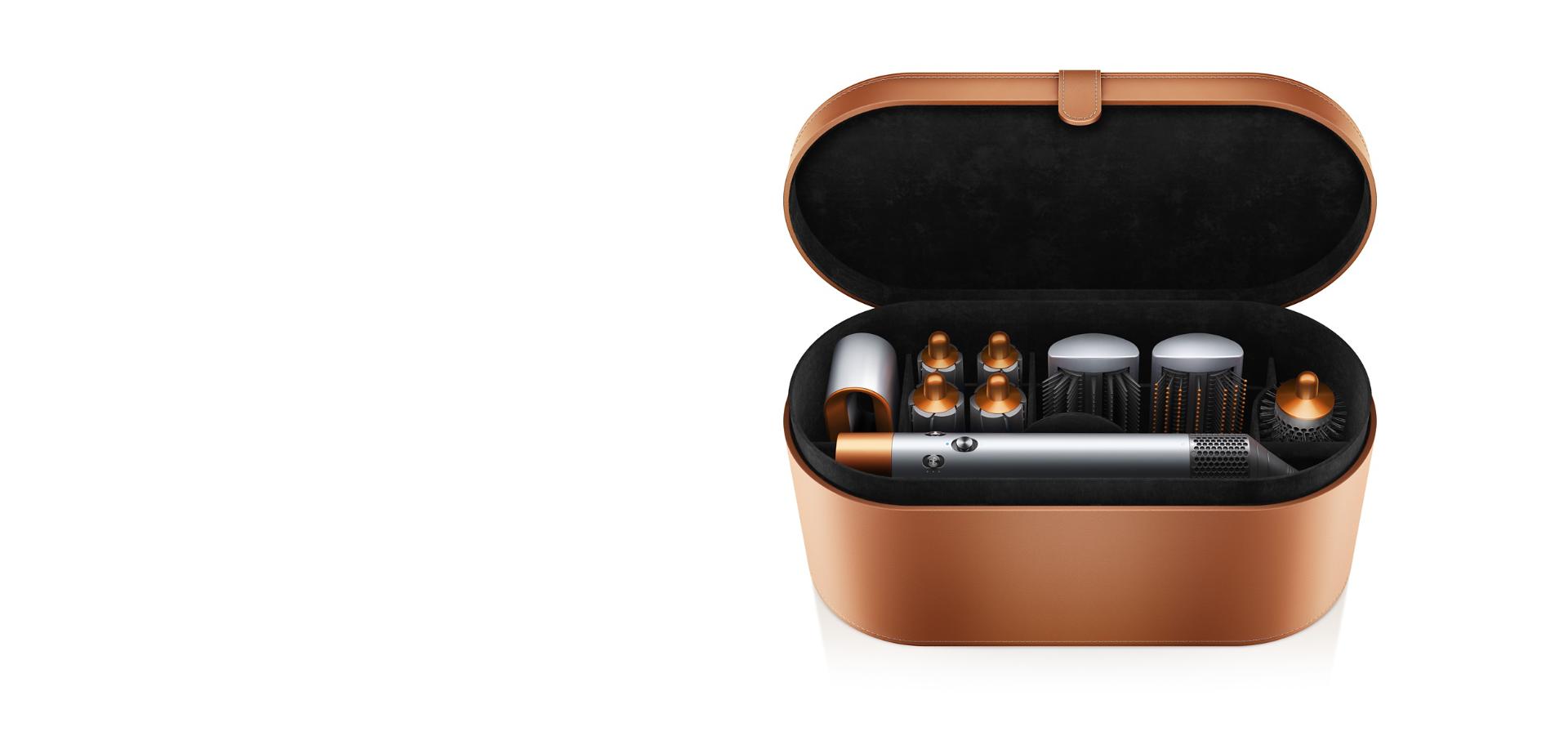 Copper Dyson Airwrap styler and attachments inside copper presentation case