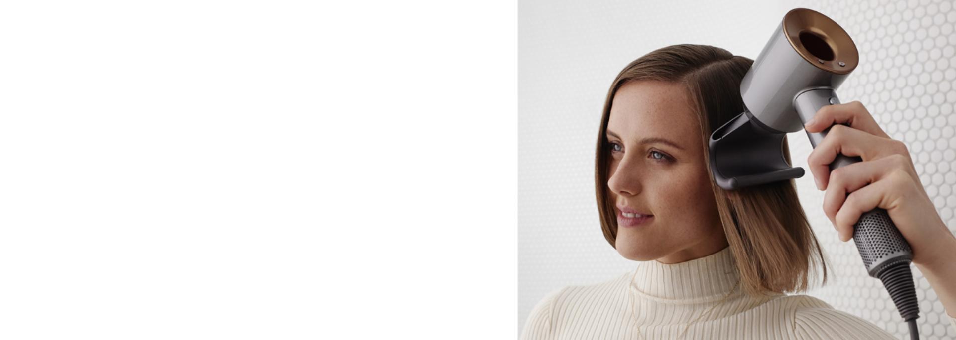 Model using a Dyson Supersonic hair dryer