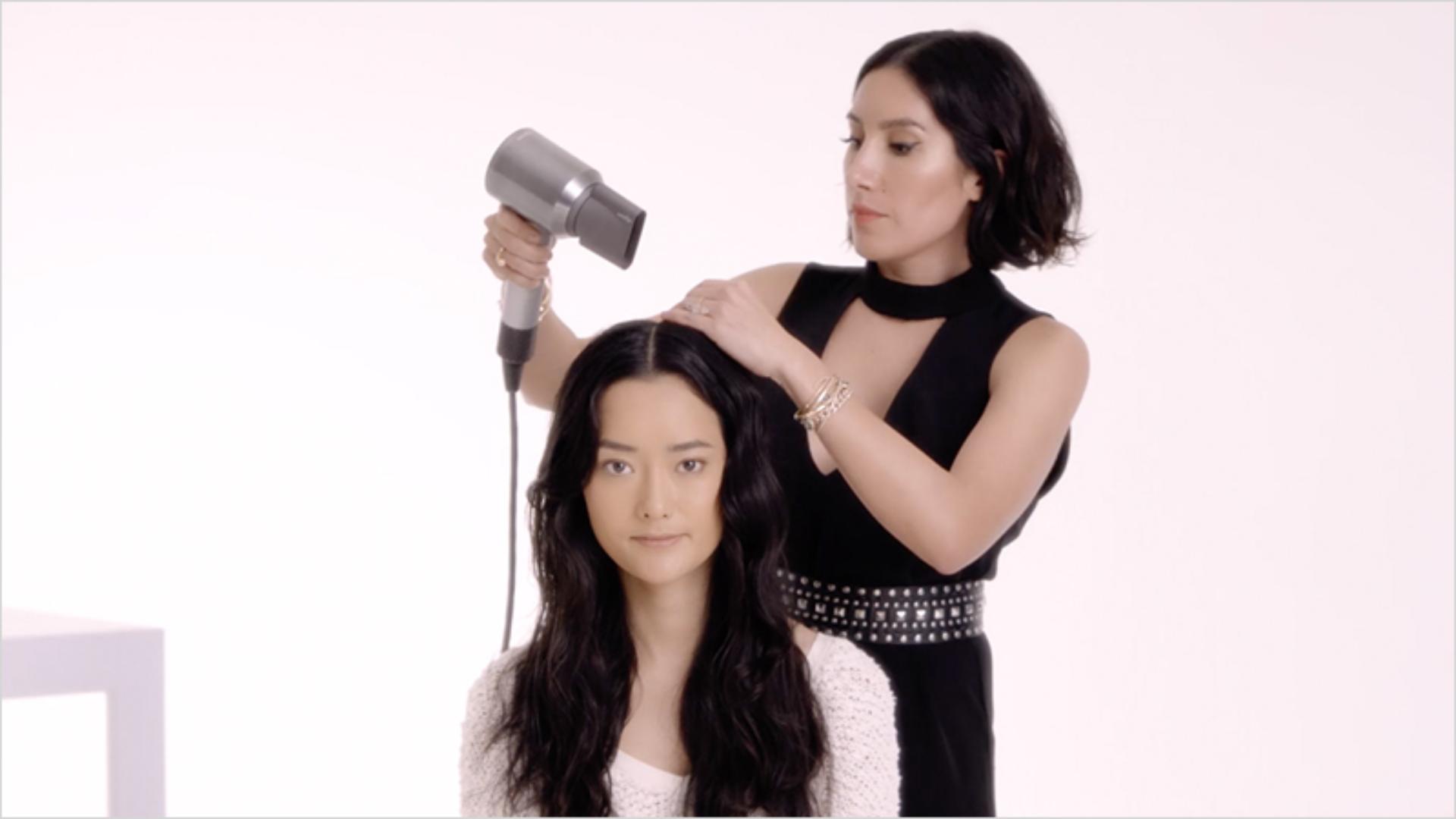Woman in salon having hair styled