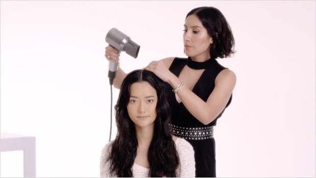 Woman in salon having hair styled