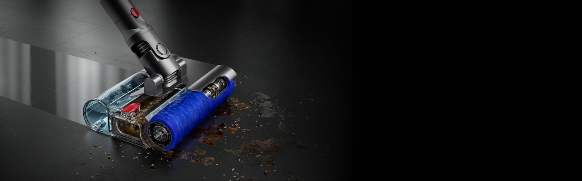 The Dyson Submarine wet roller head cleans a liquid spill from a tiled floor without leaving streaks.