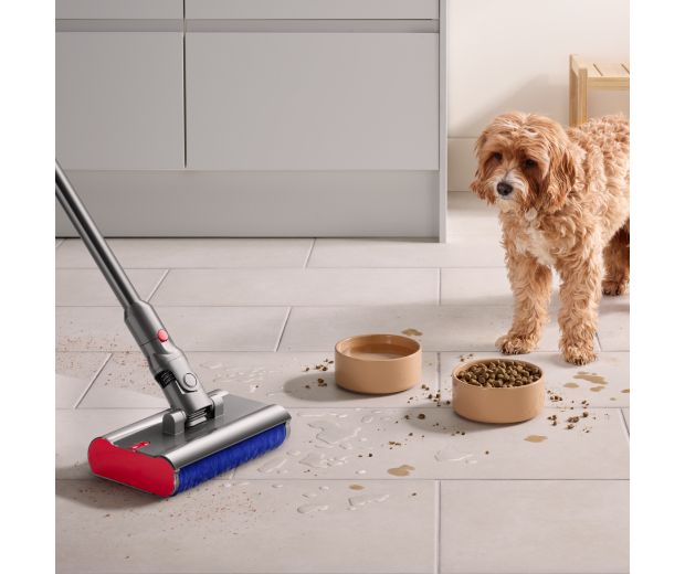A Dyson Submarine wet roller head is used to clean a spill from a dog’s food bowl.