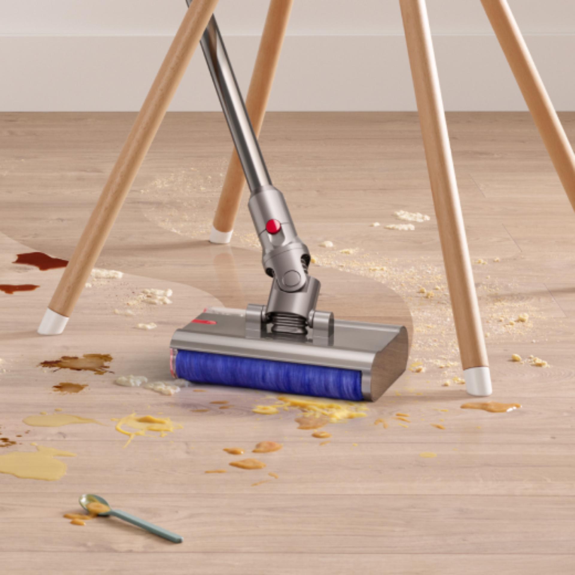 The Dyson Submarine wet roller head is used to clean around the legs of a chair.