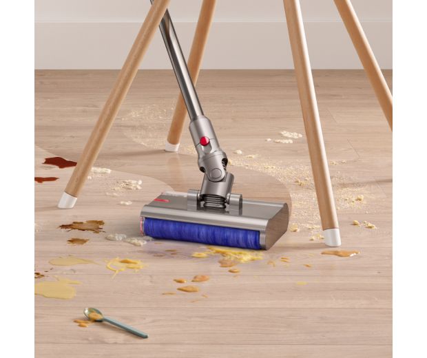 The Dyson Submarine wet roller head is used to clean around the legs of a chair.