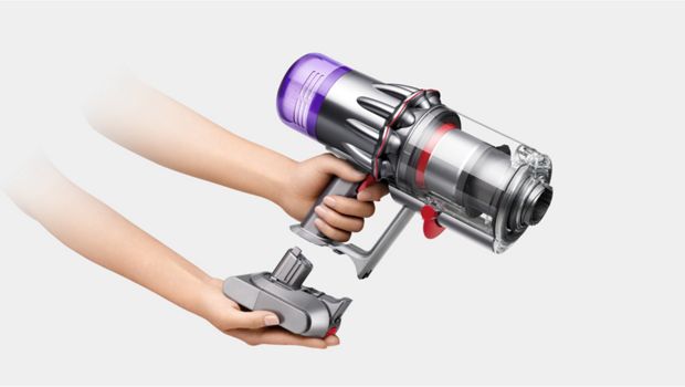 The battery is clicked into the handle of the Dyson V9 vacuum.