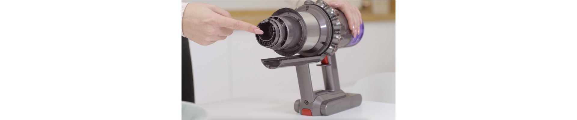 A Dyson owner checks their V9 vacuum for blockages.