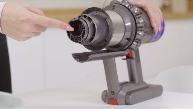 A Dyson owner checks their V9 vacuum for blockages.