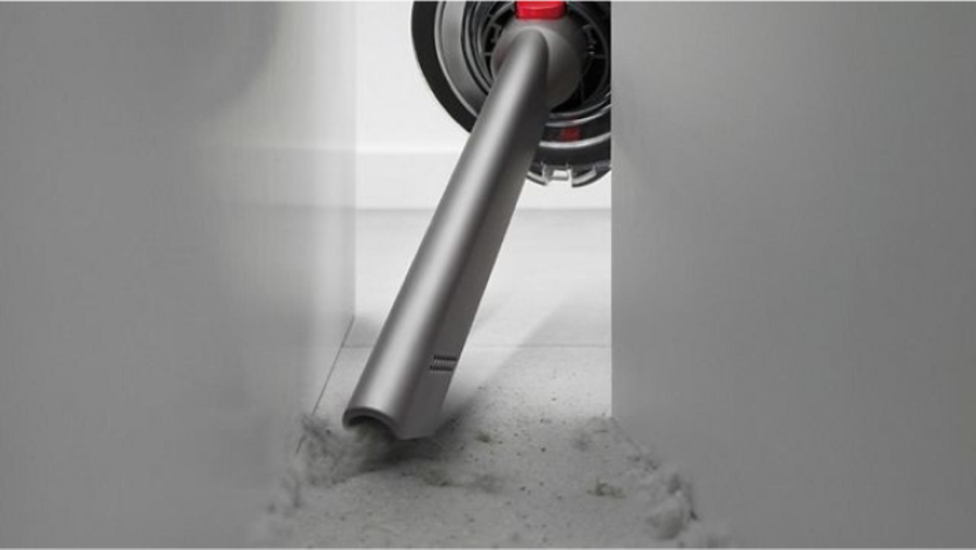 The Crevice tool is used to clean behind a cabinet.