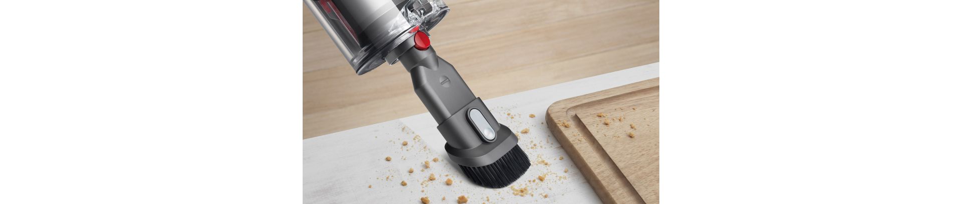 The Combination tool is used with its retractable brush to clean crumbs from a surface.