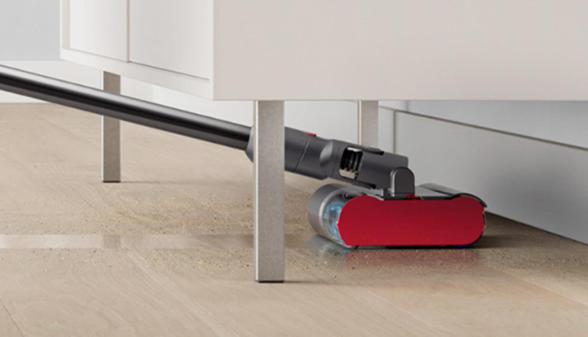 The Dyson Submarine wet roller head cleans under a low cabinet.