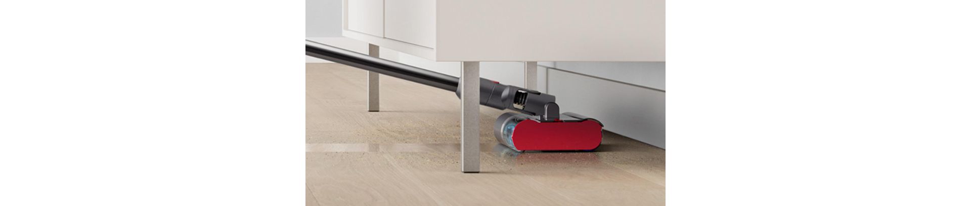 The Dyson Submarine wet roller head cleans under a low cabinet.