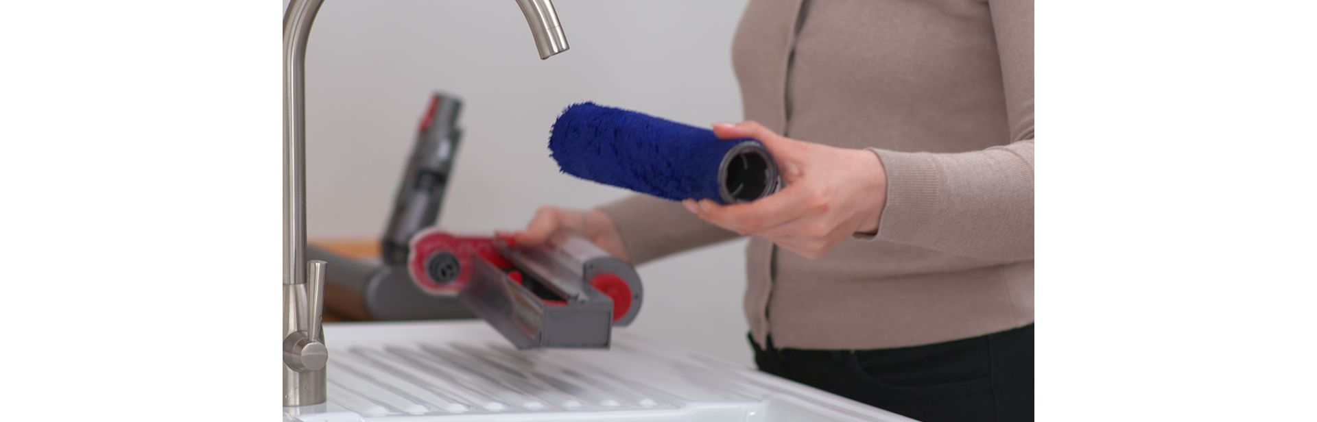 The Dyson submarine wet roller head is cleaned in a kitchen sink.