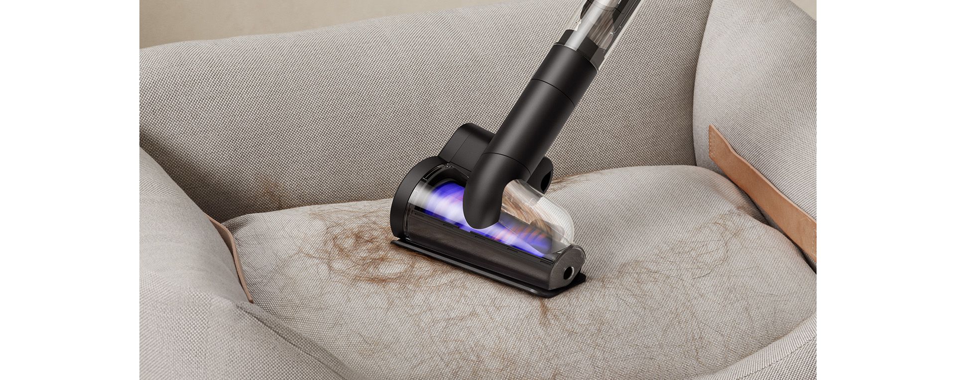The Dyson PencilVac cleaner being used with the Hair screw tool to remove pet hair from a pet bed