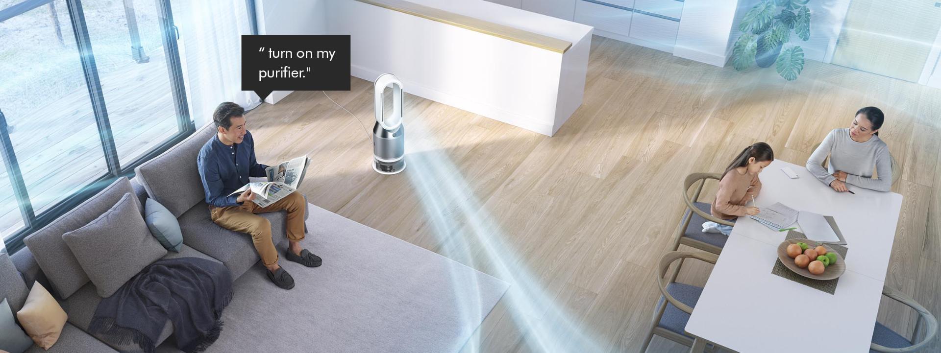 Man on a sofa asking Dyson purifier to purify a room.