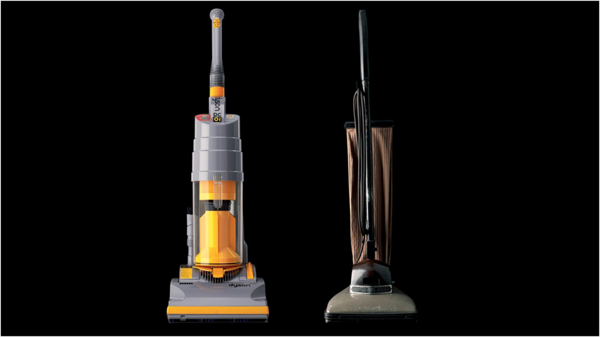 Dyson upright vacuum next to a vacuum using a bag.
